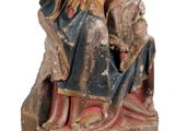 an old statue of a man and a woman sitting on a bench