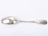 silver spoon on a white surface with a small spoon in the middle of it