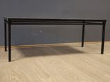 an image of a black table on a wooden floor in a room