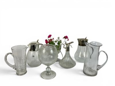 a lot of glass vases and pitchers on the table