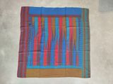 blue, red, and orange striped scarf on a white surface
