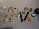 a lot of watches that are laying out on the table