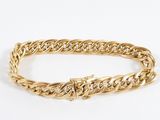 a gold chain bracelet with a diamond clasp
