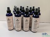 a group of six bottles of ovii body wash sitting on top of a table
