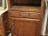 a small wooden cabinet with a drawer on top of it