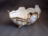 an image of a white bowl with gold trimming and flowers on it