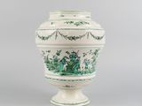an image of a green and white vase on a gray background