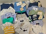 a lot of baby clothes that are on a table