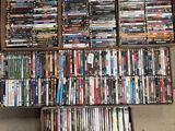 a lot of dvd ' s in a box on the floor