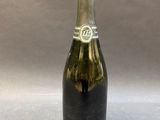 an old bottle of champagne sitting on top of a table
