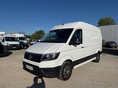 the white van is parked in a lot with other vehicles in the background