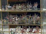 many figurines displayed in a glass case on display