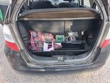 a trunk of a car with a bunch of items in it