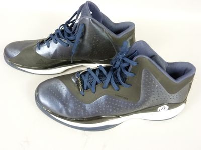 pair of gray and blue shoes with blue laces on a white surface