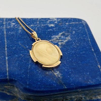 a close up of a gold locke on a blue marble block