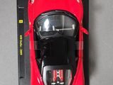a red toy car sitting on top of a black box