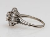 a close up of a diamond ring on a white surface