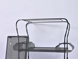 black metal bench with a basket on top of it on a white background