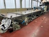 a long table that has a bunch of bags on it