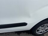 a white car with a black stripe parked in a parking lot