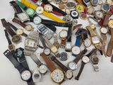 many different types of watches on a white surface