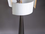 a black and white table lamp with a white shade on it