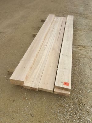 two pieces of wood sitting on top of a dirt road