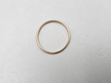 a gold ring on a white surface