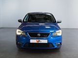 the front of a blue car in a room with a white wall
