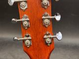 a close up of the headstock of an acoustic guitar