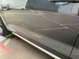 a car that is parked in a garage with its door open