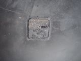 a metal pot with a square hole in the middle