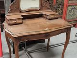 a vanity with a mirror on top of it
