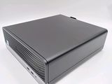 an image of a black computer sitting on top of a white surface