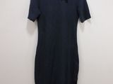 a black dress hanging on a hanger in a room