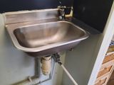 a sink in the corner of a room with a number 10 on the wall