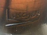 an image of a close up of a glass jar with a toothbrush in it