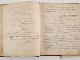 an old book with writing on it sitting on top of a table
