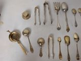 a lot of silver spoons and spoon spoons on a table