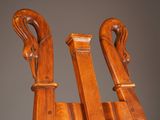 pair of antique wooden folding chairs with curved arms and legs