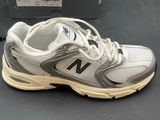 a pair of new balance shoes on a table
