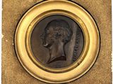 an image of a bronze medallion of a man in profile