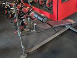 a gym room with a row of exercise machines