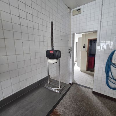 a bathroom with a toilet and a stand in it
