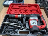 a red box with a drill and other tools on a table