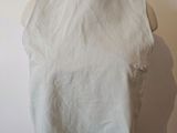 a mannequin wearing a white top on a mannequin head