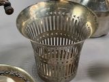 several silver objects including a teapot, a teapot, a basket, and a tea kettle