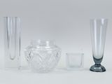 three different glass vases and a glass vase on a table