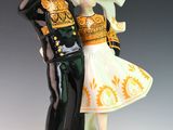a figurine of a man and a woman dressed in military clothing