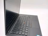 a black laptop with a red button on the keyboard